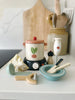 The Stir and Serve Soup Maker is a complete pretend play set with a pot, mixing bowl, blender, utensils, measuring cup, fabric napkin, wooden cutting board, and crock with kitchen tools—perfect for make-believe kitchen fun.