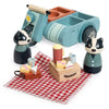 The Badger Picnic Motorbike Ride features two wooden badger figurines with a picnic playset, toy food, dishes, a red checkered blanket, and a cheerful blue motorbike and side car—an ideal addition to any countryside toy collection.