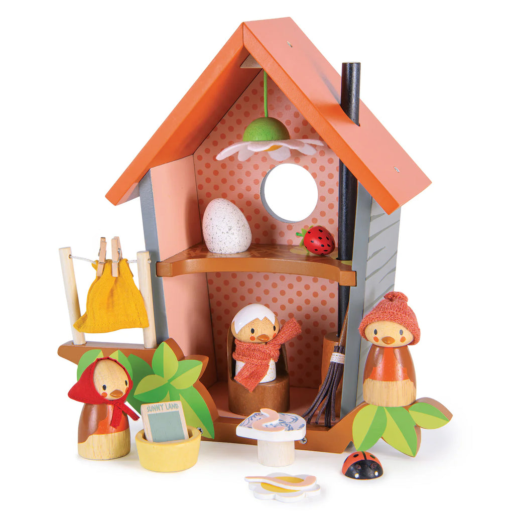 Robin's Nest Box: A wooden birdhouse playset with an orange roof, polka-dot walls, and small wooden figures in scarves and hats. Includes a toy bird family, plants, ladybug, table, and clothesline—ideal for imaginative play.