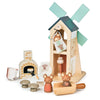 A Penny Windmill toy set featuring a windmill, an oven, two bears, pots, and utensils, all designed in soft, pastel hues. This set encourages imaginative play and story telling.