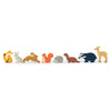 A row of colorful, wooden Woodland Animals Set including a fox, rabbits, a squirrel, a hedgehog, a badger, and a deer on an animal display stand against a white background.