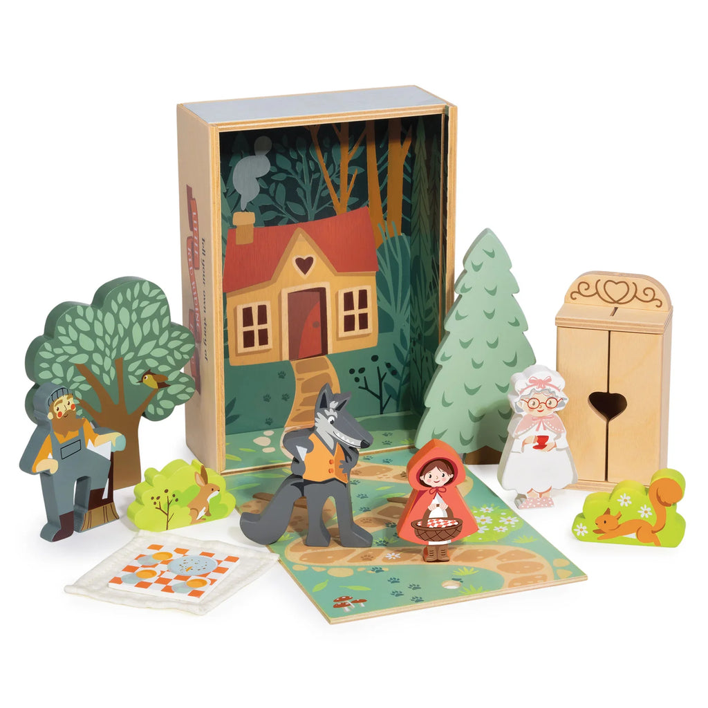 Your Story of Little Red Riding Hood includes wooden figures of Red Riding Hood, the wolf, grandmother, and more on a playmat with a plywood box featuring woodland and cottage scenes.