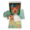Your Story of Little Red Riding Hood is a toy set with a woodland scene, featuring Little Red Riding Hood outside a house, trees, a path, and the wolf hiding under a blanket in bed—all stored in a neat plywood box.