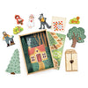 Your Story of Little Red Riding Hood is a wooden playset with character figures, trees, a house, and accessories, all set on a plywood box base illustrated with a woodland scene and forest path to a cottage.