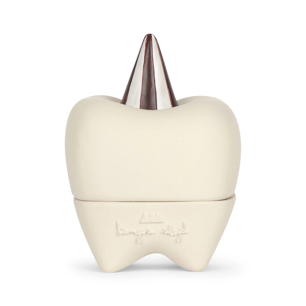 A Konges Sløjd Stone Tooth Box crafted from ceramic with a metallic, cone-shaped protrusion on top resembling a tooth's root. The lower part features an embossed logo and text. Perfect for a child's first teeth, the container has a smooth, sleek finish and minimalist design.