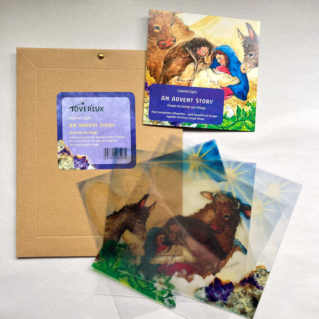 The "Silhouette Only - Layered Light: An Advent Story for Toverlux Lamp (Set of 4 Slides)" includes four recycled PET silhouette slides as transparent overlays depicting Mary, baby Jesus, a donkey, and an ox.