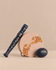 The Konges Sloejd Music Set Petite - Tiger includes a wooden tambourine with a tiger and stars illustration, a dark blue maraca, and a matching egg shaker.