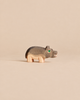 Handcrafted Ostheimer Hippopotamus - Small wooden figurine with a grey back and green eye.
