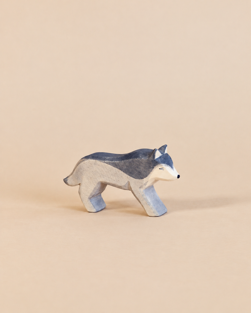 Handcrafted Ostheimer Wolf - Running wooden toy figure painted in shades of grey and white, perfect for imaginative play.