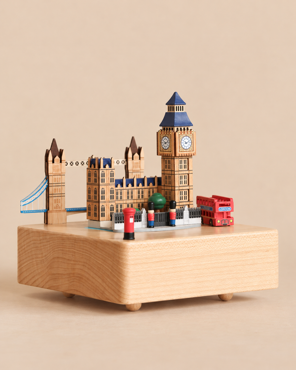 A London Music Box featuring miniature landmarks including Big Ben, Tower Bridge, a red double-decker bus, and two figures in red uniforms.