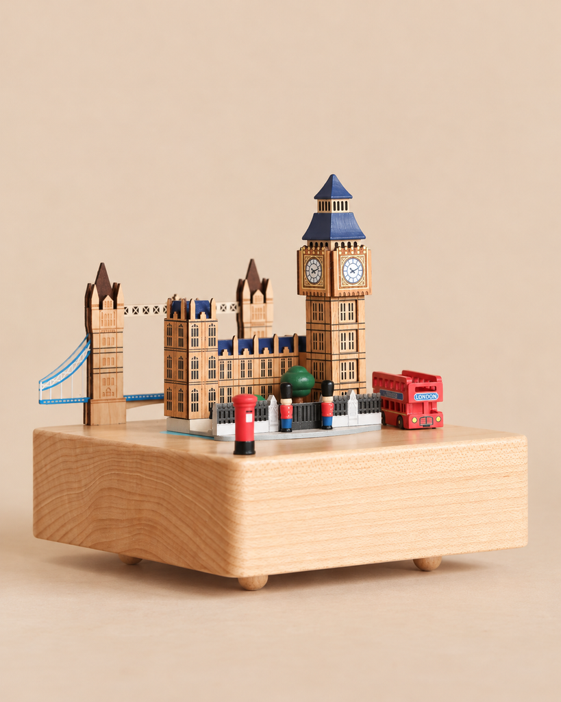A London Music Box featuring miniature landmarks including Big Ben, Tower Bridge, a red double-decker bus, and two figures in red uniforms.