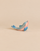 A handcrafted Ostheimer Dolphin, Head High, painted in shades of blue and pink.