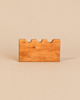 An Ostheimer Castle Wall handcrafted wooden block with a crenellated top edge.