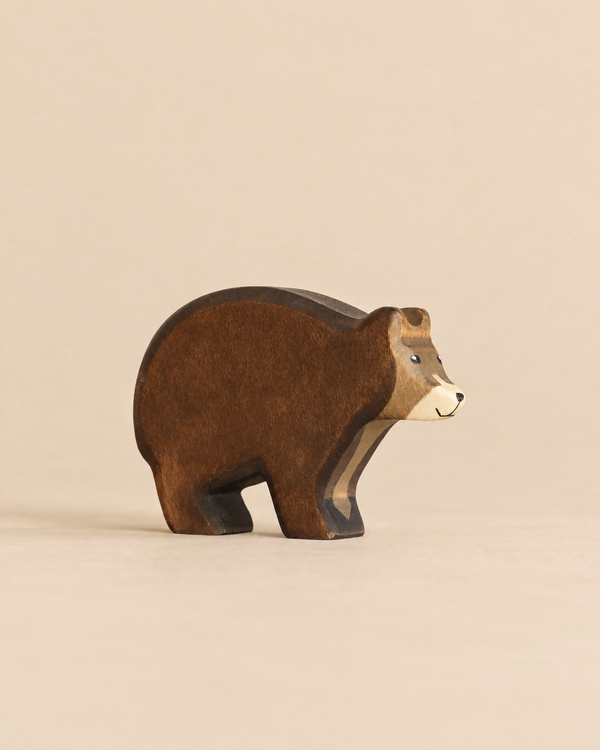 Handmade Holzwald Bear: a small, sustainable wooden toy bear in shades of brown with a light-colored face.