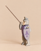 An Ostheimer Blue Knight - Riding handcrafted wooden toy in gray armor, holding a long spear and a purple shield with a fleur-de-lis emblem, perfect for imaginative play.