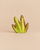 Small Bumbu Handmade Wooden Banana Bush toy shaped like a stylized green prehistoric plant leaf.
