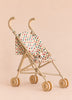 The Konges Sloejd Doll Stroller - Colored Hearts features double wooden wheels and a heart-patterned fabric seat in beige, shown against a plain beige background.