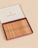 A Stockmar Hexagonal Colored Pencil Set - 18 Colors + Graphite Pencil arranged in an open metal tin.