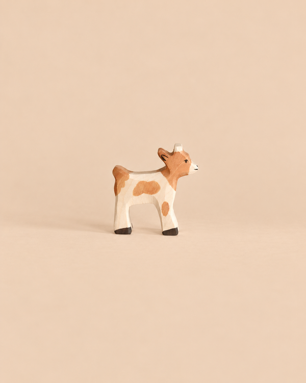 Holztiger Baby Goat handcrafted wooden toy with brown patches.