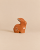 Bumbu Handmade Wooden Sitting Rabbit figurine painted with white spots and a heart on its side.