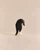 Handmade Holzwald Penguin, Head Down, a small wooden toy figurine crafted from sustainable materials shown with its head bowed downward.