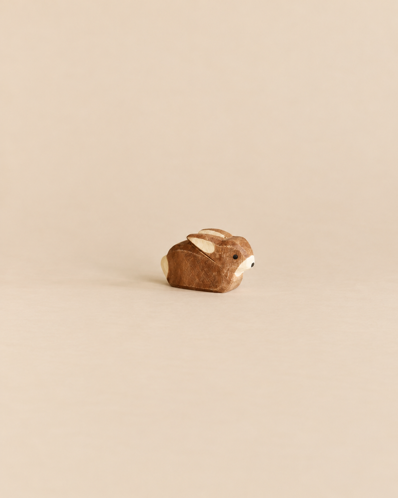 Handcrafted wooden Ostheimer Small Rabbit figurine in a sitting position.