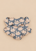 Lightweight, quilted Konges Sloejd Doll Carrier - Swan in grey fabric with a repeating swan print and a ruffled collar.