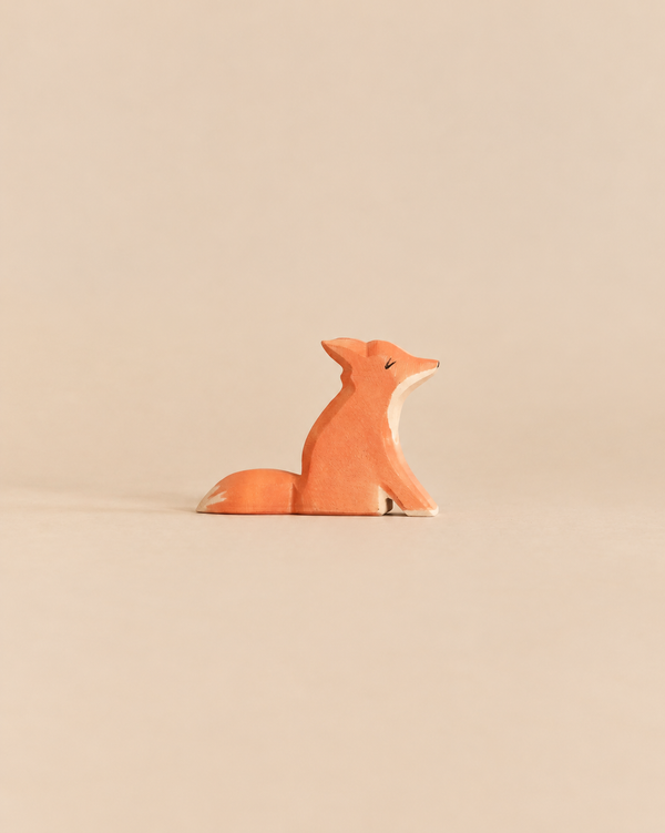 Ostheimer Small Fox - Sitting, a handcrafted wooden toy fox with its head turned to the side, perfect for imaginative play.