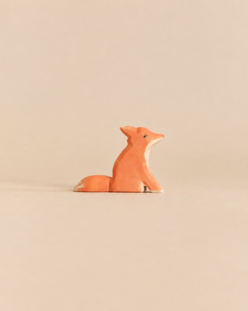 Ostheimer Small Fox - Sitting, a handcrafted wooden toy fox with its head turned to the side, perfect for imaginative play.