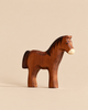 A dark brown Handmade Holzwald Horse - Dark Brown figurine standing in profile, designed for imaginative play.