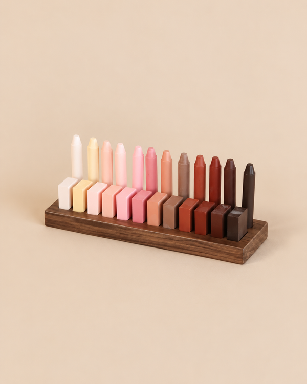 Wooden Crayon Holder 12 Stick / 12 Block Slots displaying twelve tall crayon sticks and twelve rectangular crayon blocks arranged in a gradient from cream to dark brown.
