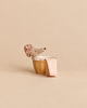 A Maileg Wellness Mouse, Big Sister (Rose) wearing a floral shower cap sits in a small yellow basin with a striped towel draped over the side.