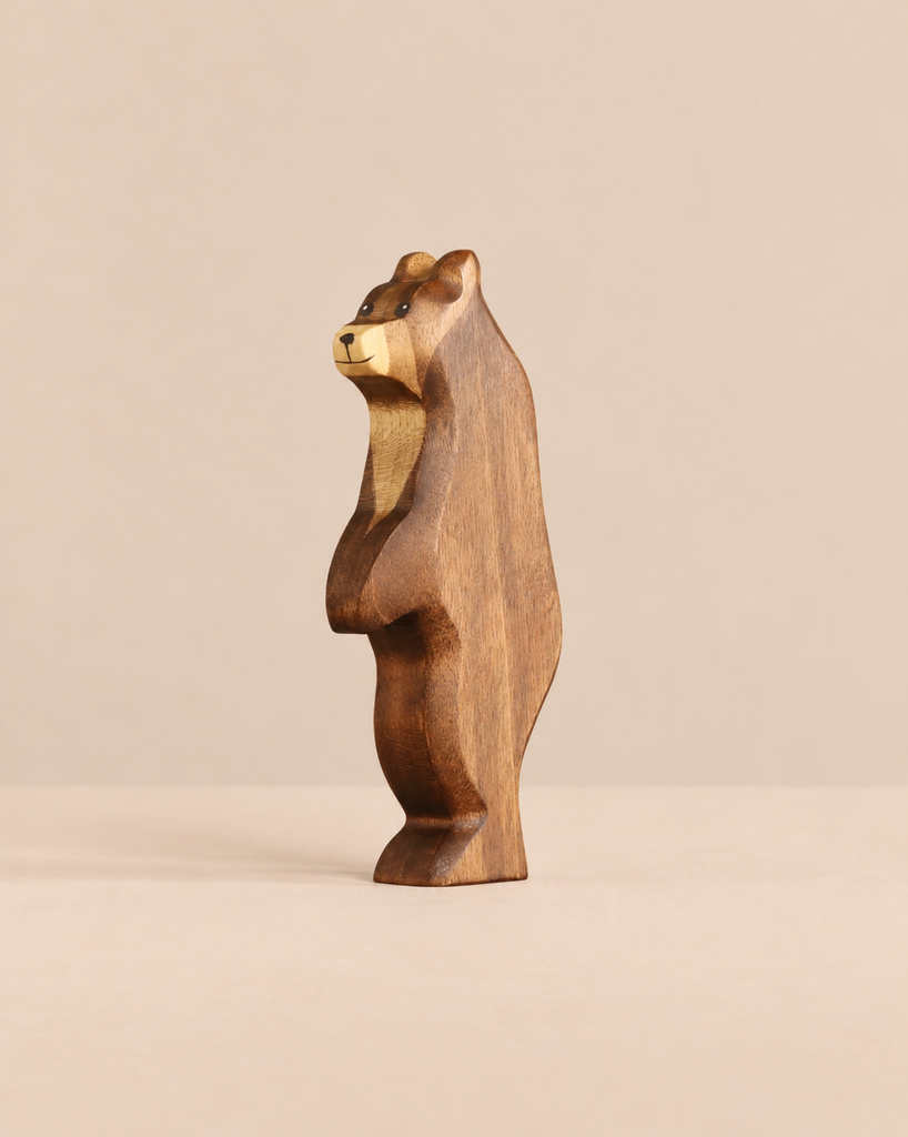 A Handmade Holzwald Bear - Standing, a carved wooden figurine of a bear in profile designed for imaginative play.