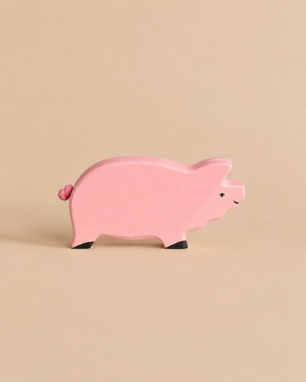 Holztiger Pig handcrafted wooden toy, painted pink with small black hooves.
