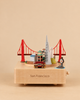 San Francisco Wooden Music Box featuring miniature landmarks, including the Golden Gate Bridge, the Transamerica Pyramid, a cable car, and a sea lion.