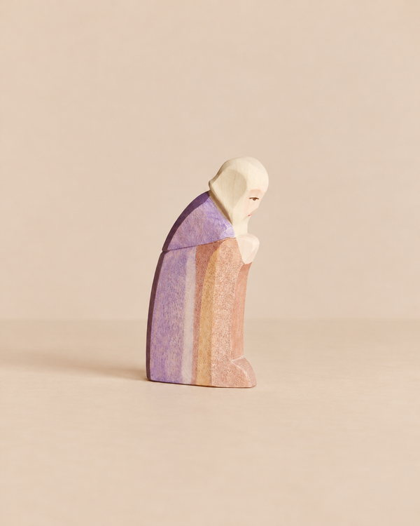 Hand-carved Ostheimer Joseph wooden figurine of a man in a head covering and robe, shown in profile with his head bowed for imaginative play.