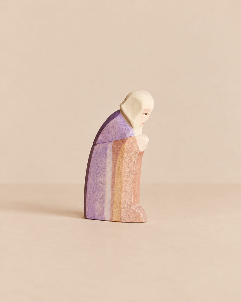 Hand-carved Ostheimer Joseph wooden figurine of a man in a head covering and robe, shown in profile with his head bowed for imaginative play.