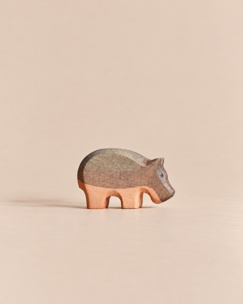 Handmade Holzwald Small Hippo figurine featuring two-toned natural wood grain, perfect for imaginative play.