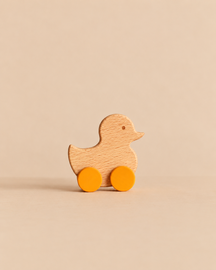 Sabo Concept Rolling Duck - Yellow, an heirloom-quality wooden duck toy on two yellow wheels.
