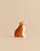 Handmade Holzwald Sitting Tiger figurine in a sitting pose, painted orange with black stripes.