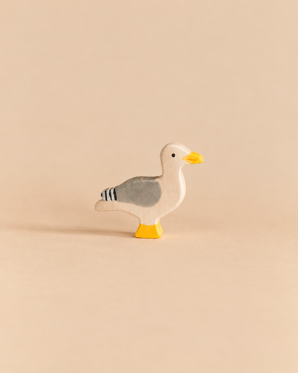Holztiger Seagull handcrafted wooden toy with gray wings and a yellow beak and feet.