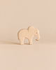An Ostheimer Small Elephant - Eating, a small, handcrafted wooden elephant figurine with its trunk pointed downward.