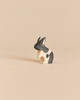 An Ostheimer Black & White Rabbit - Standing, a small, handcrafted wooden figurine of a rabbit standing upright, painted with black and white patches.