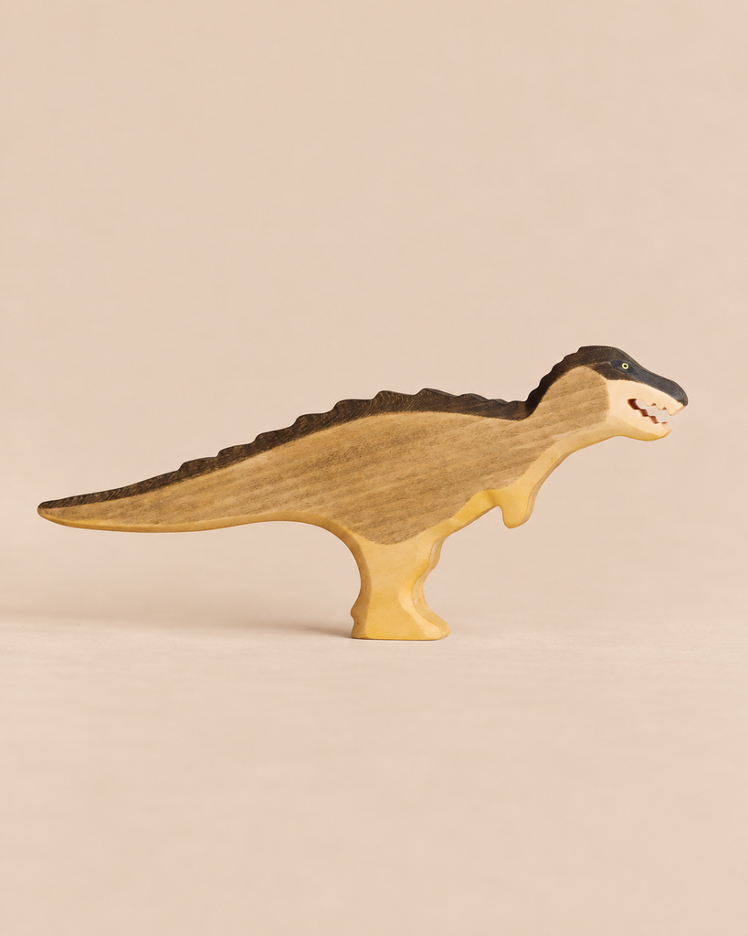 A handmade Holzwald Dinosaur toy featuring a dark-stained back and head.