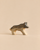 A handmade Holzwald Wolf figurine featuring a grey and brown stained back.