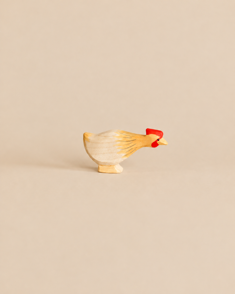 Ostheimer Long Neck Hen - Ochre, a handcrafted wooden hen figurine featuring an ochre-painted neck and a bright red comb.