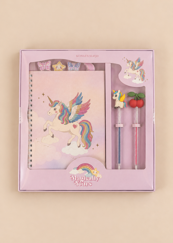 A Konges Sloejd My Stationery Box - Unicorn containing a pink A5 spiral-bound notebook with a unicorn illustration, four shaped paper clips, and two glitter gel pens topped with a unicorn and two cherries.