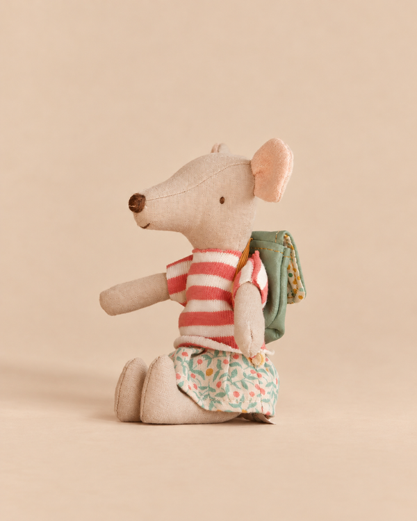 Maileg Tricycle Mouse, Big Sister - Green wearing a striped shirt, a floral skirt, and a small green mouse backpack.