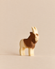 Handmade wooden figurine of a goat with brown and natural wood markings, from the Handmade Holzwald Farm Animals Set.