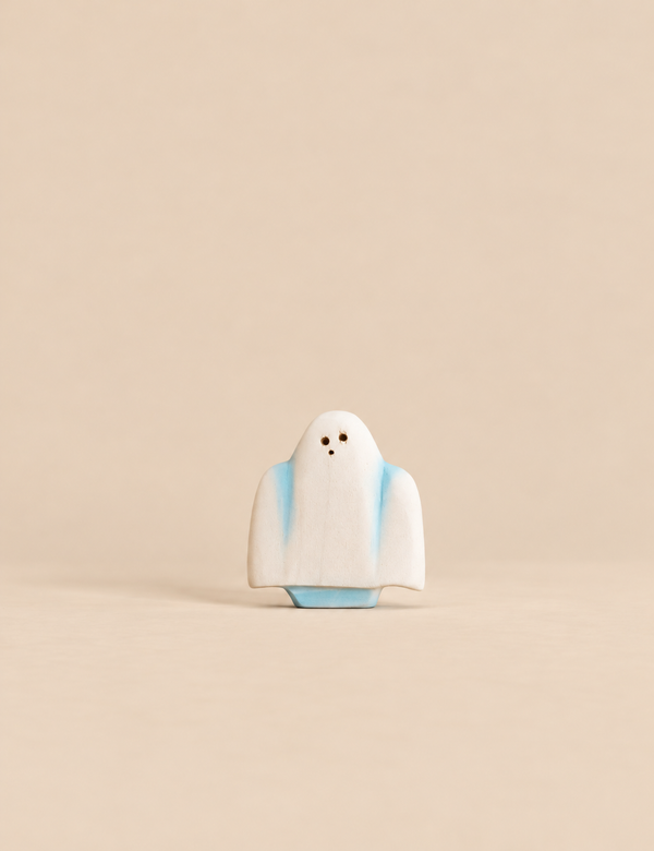Bumbu Handmade Wooden Ghost figurine with a white body, blue accents, and three small dark dots for eyes and a mouth.